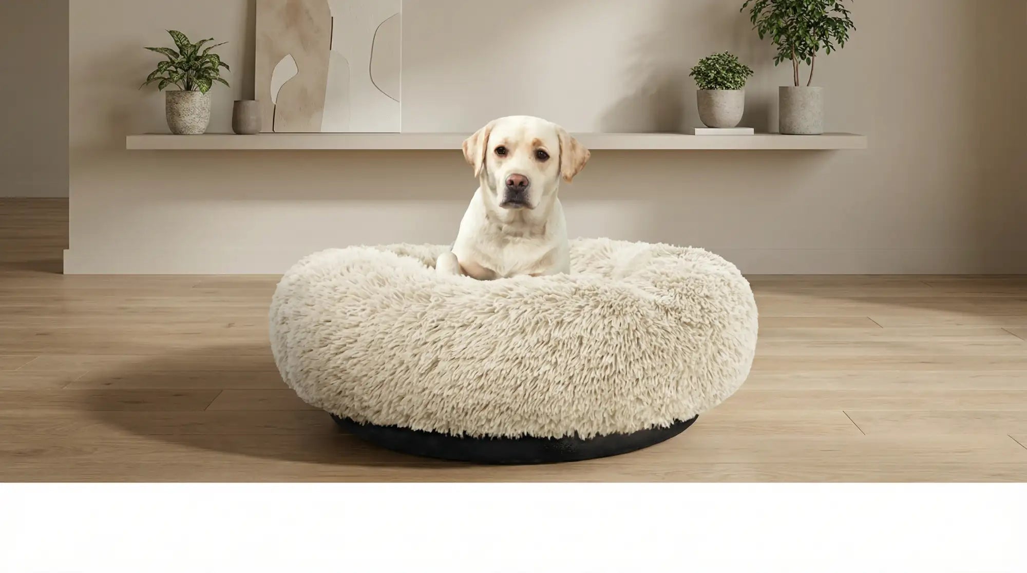 Cream-colored, plush faux fur dog bed with a black base.